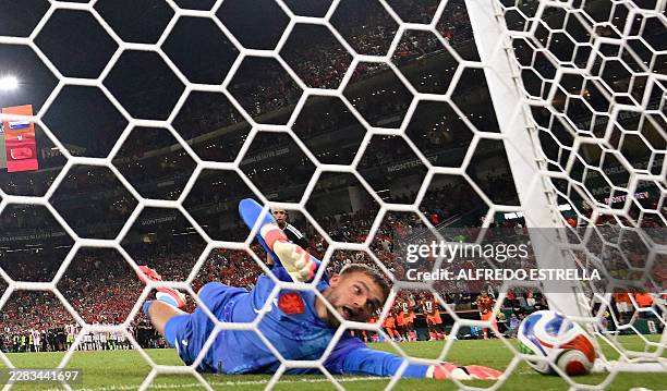 Netherlands goalkeeper Bart Verbruggen concedes a penalty goal by Morocco forward Soufiane Rahimi during the penalty shootout of the 2026 World Cup...