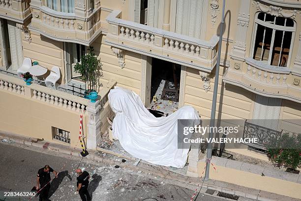 Members of a bomb disposal team operate the day after an allaged attack involving an explosive device in the lobby of a residential building, in...