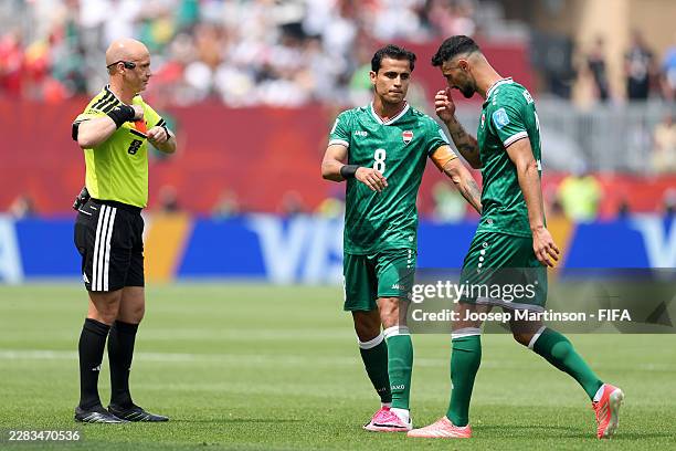 Rebin Ghareeb of Iraq is consoled by Ibrahim Bayesh of Iraq after receiving a red card by Referee Anthony Taylor after the VAR review during the FIFA...