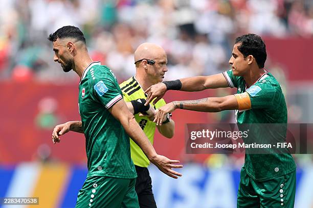 Rebin Ghareeb of Iraq is consoled by Ibrahim Bayesh of Iraq after receiving a red card by Referee Anthony Taylor after the VAR review during the FIFA...