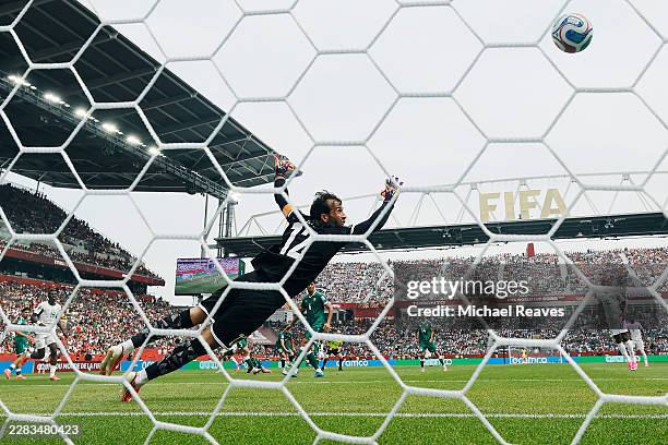Jalal Hassan of Iraq dives in vain as Pape Gueye of Senegal scores his team's third goal during the FIFA World Cup 2026 Group I match between Senegal...