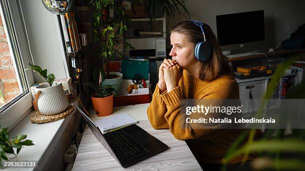 a moment of thought: a woman in headphones, a pause. - computer security protocol stock pictures, royalty-free photos & images