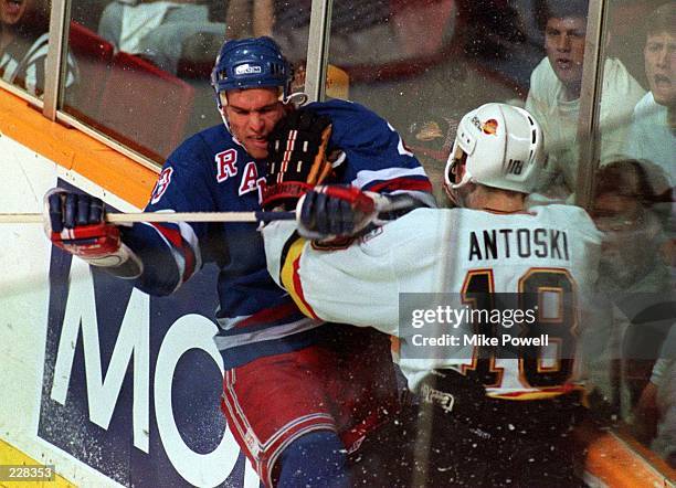 RANGER''S CENTER SERGEI NEMCHINOV AND THE CANUCK''S SHAWN ANTOSKI BATTLE AGAINST THE BOARDS DURING THE FIRST PERIOD OF GAME SIX OF THE STANLEY CUP...