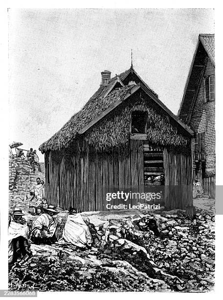 rustic timber prison structure with a thatched roof nestled along a rocky hillside terrain - thatched cottage stock illustrations