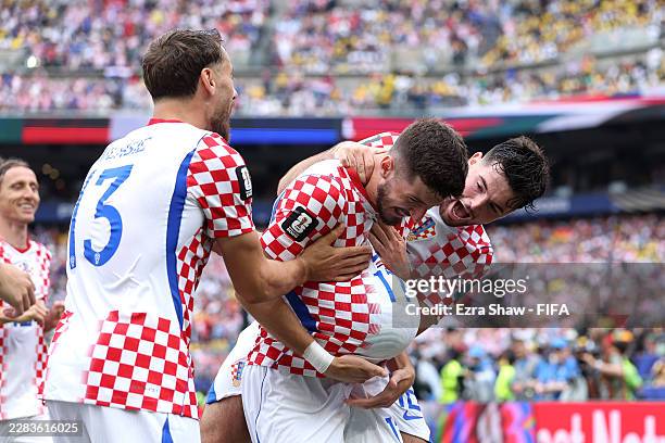Petar Sucic of Croatia celebrates with teammates after scoring his team's first goal during the FIFA World Cup 2026 Group L match between Croatia and...