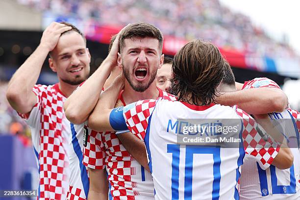 Petar Sucic of Croatia celebrates with teammates after scoring his team's first goal during the FIFA World Cup 2026 Group L match between Croatia and...