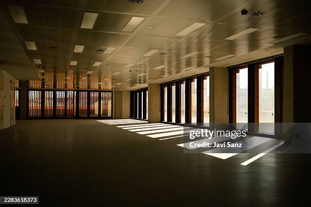 empty modern open plan office with strong sunlight - spacious office stock pictures, royalty-free photos & images