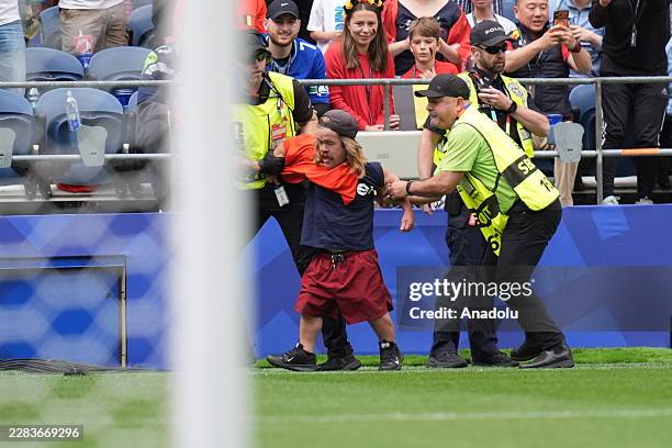 Pitch invader is apprehended by security during the 2026 FIFA World Cup Round of 32 match between Belgium and Senegal at Lumen Field in Seattle,...