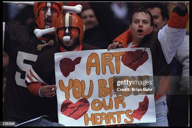 Fans of the Cleveland Browns at Cleveland Stadium in Cleveland, Ohio, express their disappointment and sense of unfairness at the fact their team is...