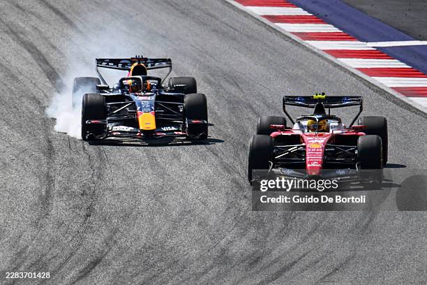 Lewis Hamilton of Great Britain driving the Scuderia Ferrari SF-26 leads Max Verstappen of the Netherlands driving the Oracle Red Bull Racing RB22...