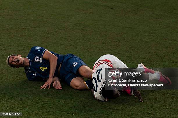 United States forward Folarin Balogun and Bosnia and Herzegovina defender Tarik Muharemovic are seen on the field after coming together during the...