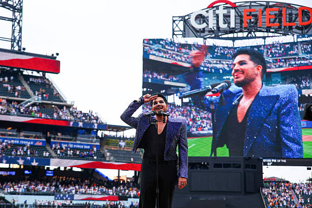 Adam Lambert performs the national anthem prior to the game between the Philadelphia Phillies and the New York Mets at Citi Field on Friday, June 26,...