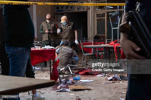 Investigators and emergency responders survey the damage from an explosion that killed five people at a cafe on July 2, 2026 in Damascus, Syria. The...