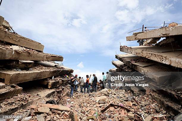 Rescuers continue to search for victims and work at a collapsed building after a magnitude 7.2 earthquake struck Venezuela and other regions in the...