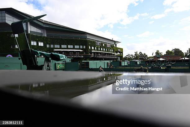 General view as a member of ground staff paints the lines on court on day one of The Championships Wimbledon 2026 at All England Lawn Tennis and...