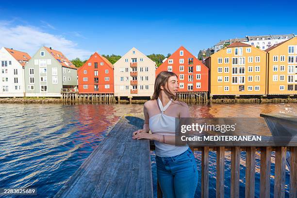 trondheim female tourist enjoying view from wooden lookout on nidelva river - trondheim stock pictures, royalty-free photos & images