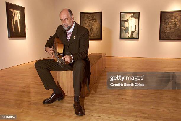 Mick Fleetwood plays Stuart Sutcliffe's first guitar at a press conference to unveil the artwork and memoriblia of Mr. Sutcliffe, the "5th Beatle",...