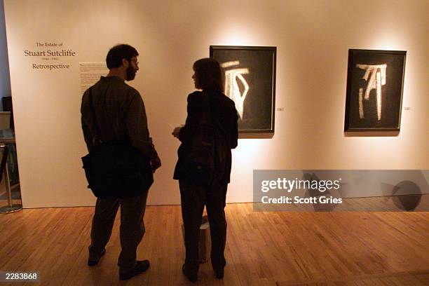 Patrons at a press conference to unveil the artwork and memoriblia of the "5th Beatle" Stuart Sutcliffe at the Westwood Gallery in New York City. The...