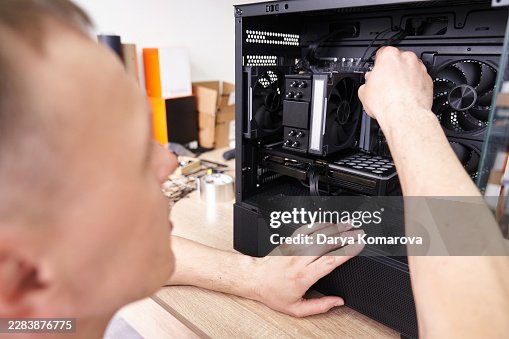 Computer technician installing memory into a desktop PC Computer technician installing memory into a desktop PC