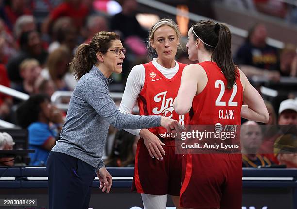 Stephanie White the head coach of the Indiana Fever gives instructions to Sophie Cunningham and Caitlin Clark against the Atlanta Dream at Gainbridge...