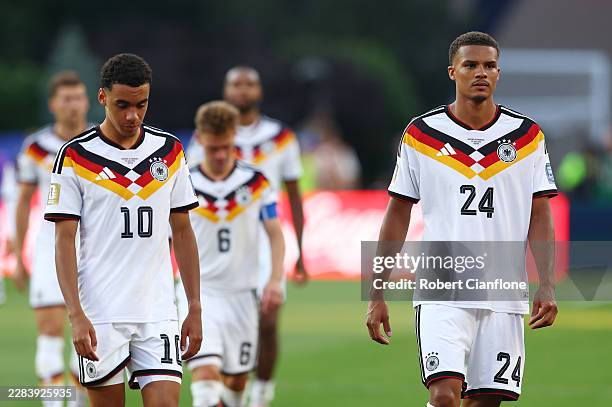 Jamal Musiala and Malick Thiaw of Germany react after the penalty shootout loss during the FIFA World Cup 2026 Round Of 32 match between Germany and...