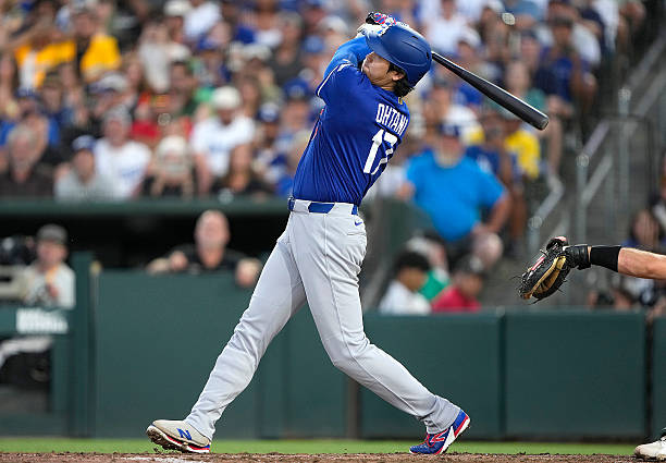 Shohei Ohtani of the Los Angeles Dodgers hits a three-run home run against the Athletics in the top of the six inning at Sutter Health Park on June...