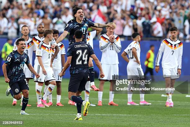 Mauricio Magalhaes Prado of Paraguay celebrates with teammates after Jose Canale scores the winning penalty in a penalty shootout during the FIFA...