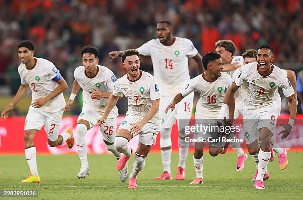 Players of Morocco dash as Ismael Saibari of Morocco scores the team's fifth and winning penalty during hte penalty shootout in the FIFA World Cup...