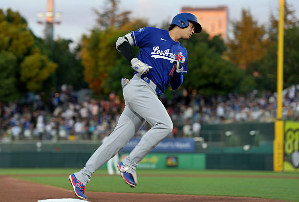Shohei Ohtani of the Los Angeles Dodgers trots around the bases after hitting a three-run home run against the Athletics in the top of the six inning...