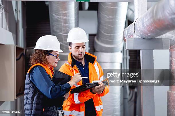 engineering team recording mechanical system inspection data during facility maintenance - system admin stock pictures, royalty-free photos & images