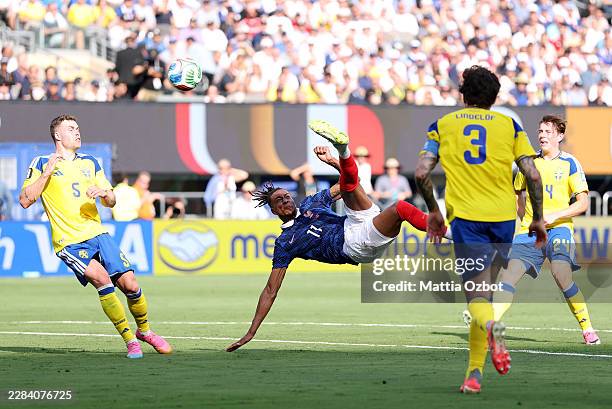 Michael Olise of France attempts an overhead kick against Gabriel Gudmundsson of Sweden during the FIFA World Cup 2026 Round Of 32 match between...