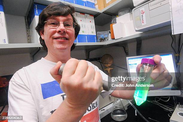 Portrait of University of Texas biochemistry professor Andrew Ellington as he poses with a vial of fluorescent liquid, Austin, Texas, February 20,...