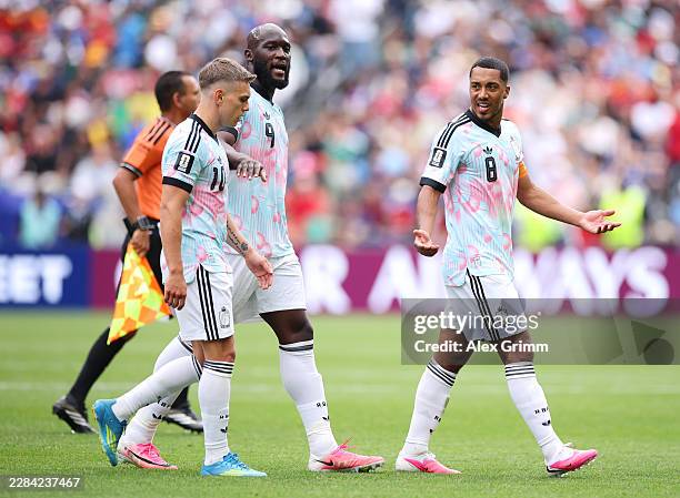 Leandro Trossard and Youri Tielemans of Belgium have words while Romelu Lukaku intervenes during the FIFA World Cup 2026 Round Of 32 match between...