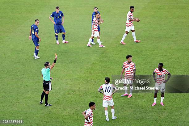 Referee Raphael Claus shows Folarin Balogun of the United States a red card for a foul on Tarik Muharemovic of Bosnia and Herzegovina during the FIFA...