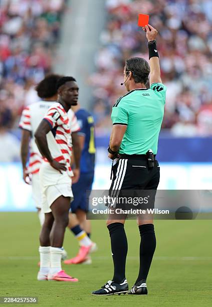 Referee Raphael Claus shows Folarin Balogun of the United States a red card for a foul on Tarik Muharemovic of Bosnia and Herzegovina during the FIFA...
