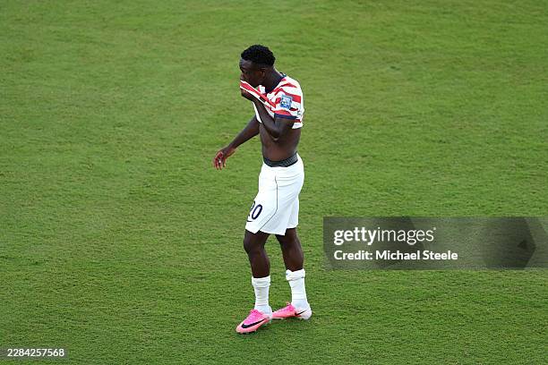 Folarin Balogun of the United States reacts to receiving a red card for a foul on Tarik Muharemovic of Bosnia and Herzegovina during the FIFA World...