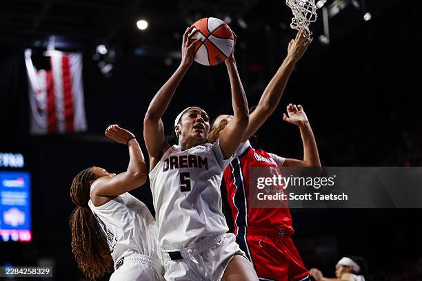 Angel Reese of the Atlanta Dream grans a rebound in front of Lauren Betts of the Washington Mystics during the second half of the game at CareFirst...