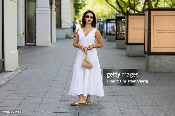 Bella Emar wears Massimo Dutti white dress, beige Byrein bag, Birkenstock Shoes, Le specs Sunnies, Rolex Datejust watch during the Berlin Fashion...