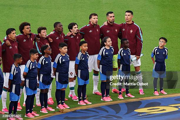Cristiano Ronaldo of Portugal and teammates stand for the national anthem before the FIFA World Cup 2026 Round of 32 match between Portugal and...