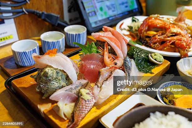 we had lunch at a seafood restaurant in front of shimoda station.sashimi set meal with simmered scallops. - izu peninsula stock pictures, royalty-free photos & images