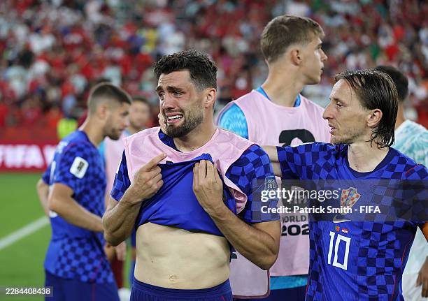 Mateo Kovacic and Luka Modric of Croatia react after the 1-2 loss during the FIFA World Cup 2026 Round of 32 match between Portugal and Croatia at...