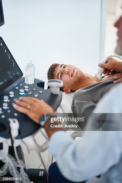 doctor performing thyroid ultrasound examination - diagnostic medical tool stock pictures, royalty-free photos & images