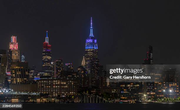 The Empire State Building illuminates in blue to mark the wedding of Taylor Swift in New York City on July 03 as seen from Hoboken, New Jersey.