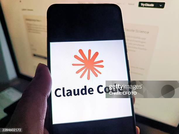 Netizen is using his mobilephone to view Claude Code logo and using his computer to view Claude Code webpage in Suqian, Jiangsu, China on July 8,...