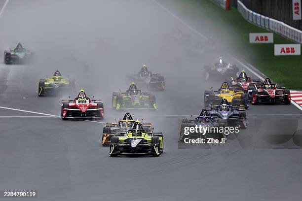 Felipe Drugovich of Brazil driving the Andretti Formula E Porsche 99X Electric leads the field into turn one at the start during the Shanghai E-Prix,...