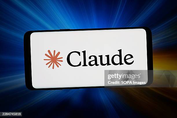 In this photo illustration, the generative AI software Claude logo is seen displayed on a smartphone in front of an abstract background on a computer...