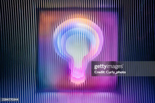 a glowing, multicolored lightbulb viewed through distorted ribbed glass. - scanlines stock pictures, royalty-free photos & images