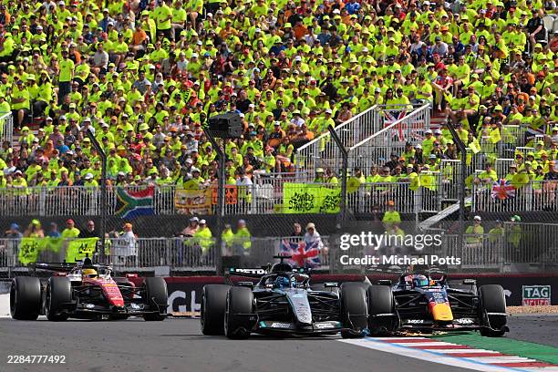 George Russell of Great Britain driving the Mercedes AMG Petronas F1 Team W17 battles with a sparking Max Verstappen of the Netherlands driving the...