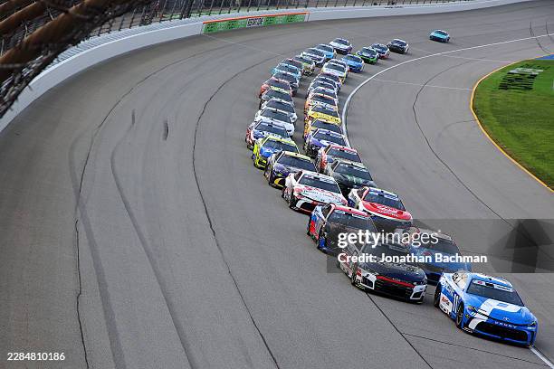 Denny Hamlin, driver of the Progressive Insurance Toyota, and Kyle Larson, driver of the HendrickCars.com Chevrolet, lead the field during the NASCAR...