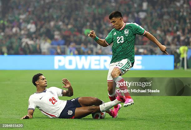 Jesus Gallardo of Mexico is tackled by Jarell Quansah of England during the FIFA World Cup 2026 Round of 16 match between Mexico and England at...